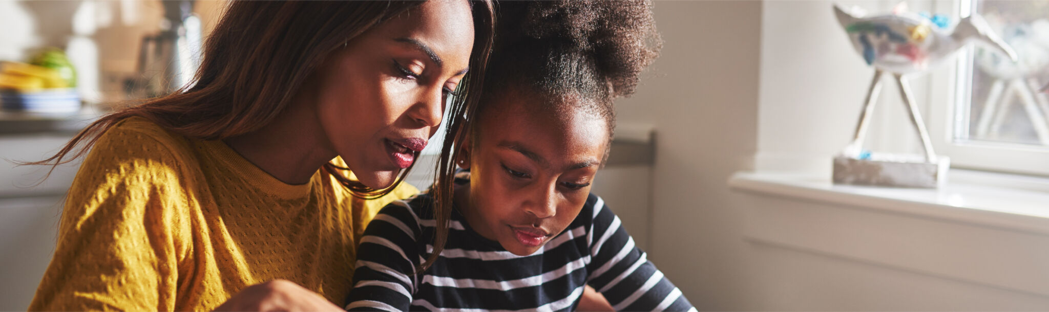 mother and daughter colouring a poster